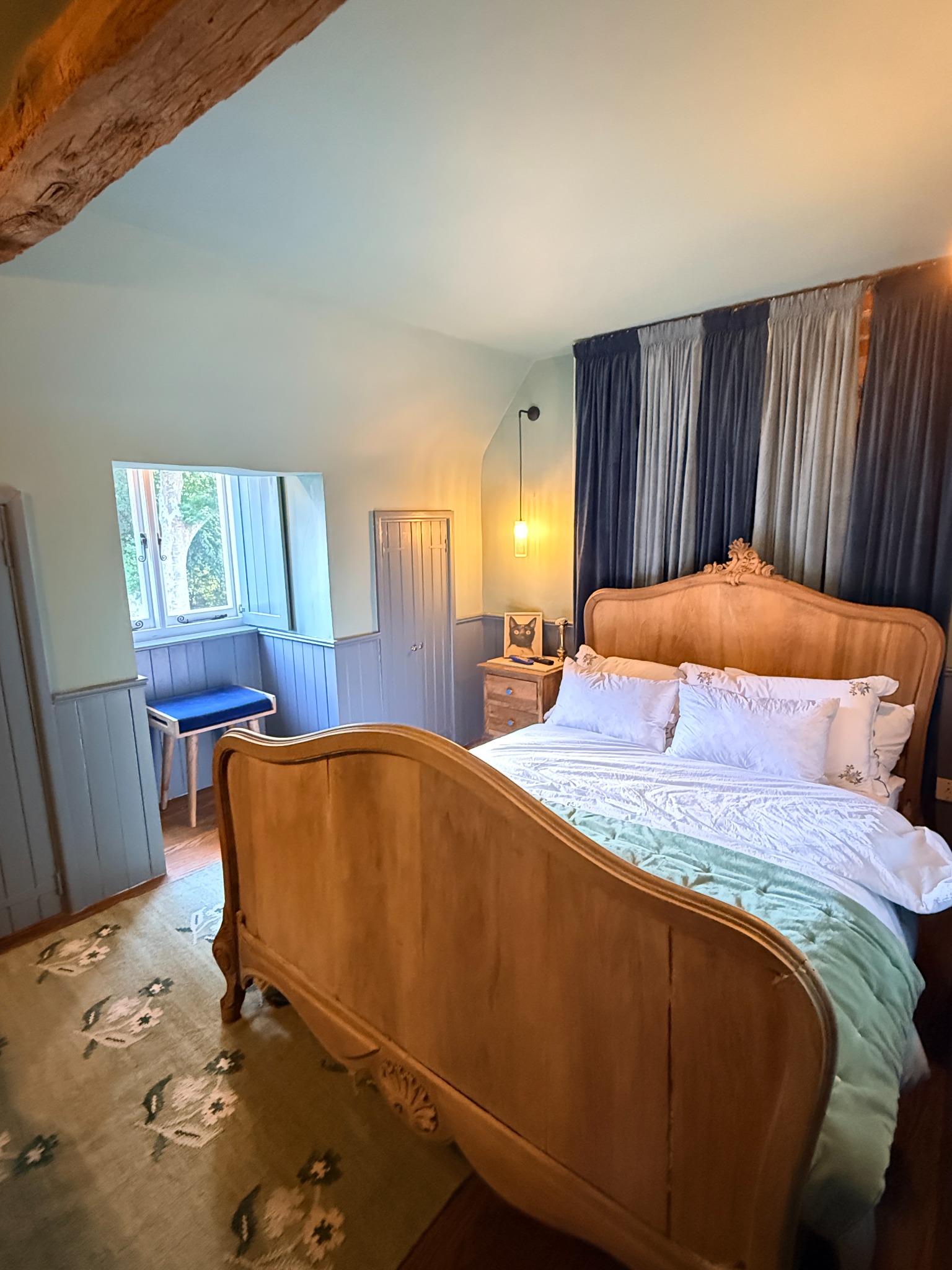 Blue-toned bedroom with styled furniture and textiles