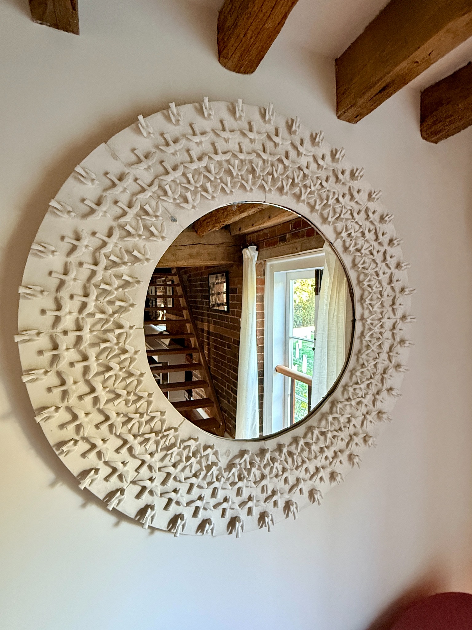 Decorative sculptural round mirror created by Kirstene